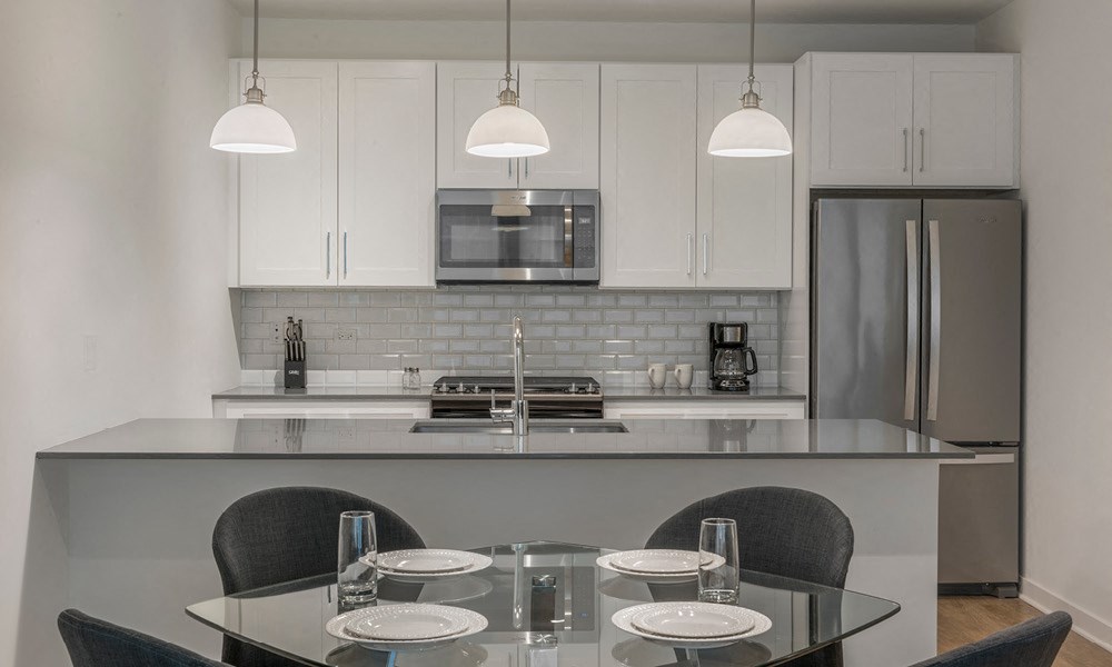 modern kitchen with gray and white accessories at Kelmscott Park Apartments in Lake Forest, IL