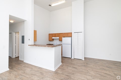 A kitchen with white cabinets and a wooden island.