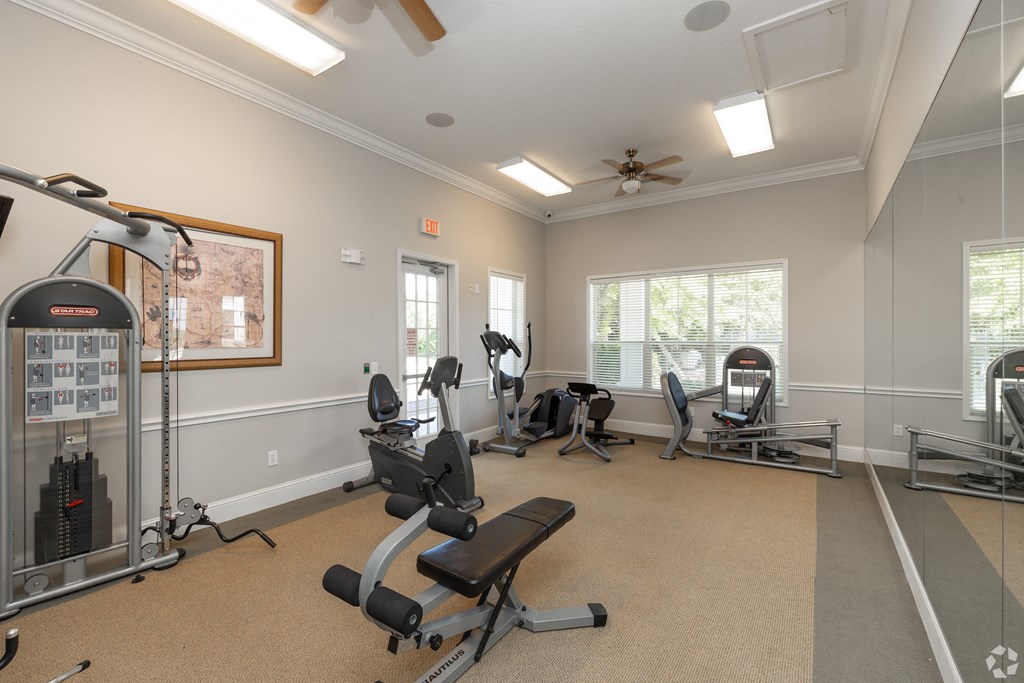 A spacious home gym with a variety of exercise equipment.