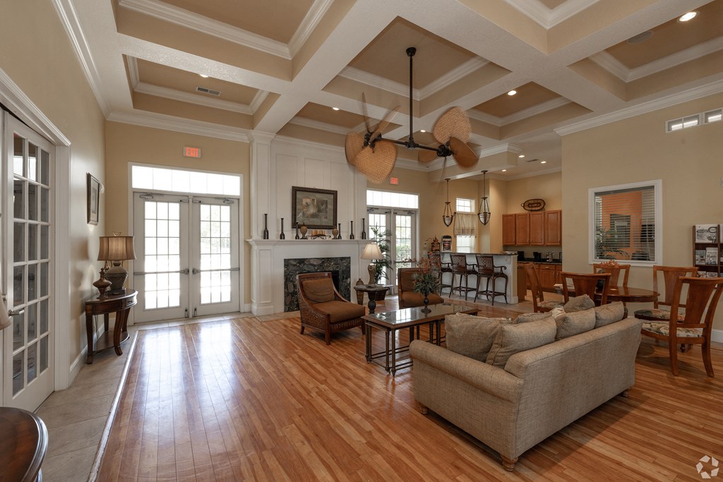 A living room with a couch, chairs, and a fireplace.