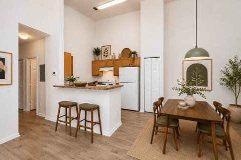 A kitchen with a table and chairs in the middle of the room.