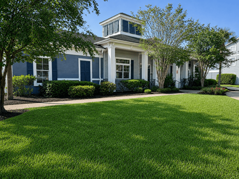 A white house with a blue trim and a white porch.