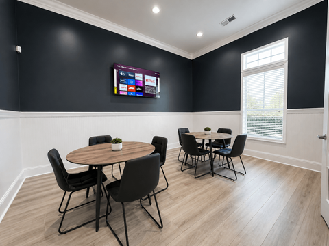 A black and white room with a round table and chairs.