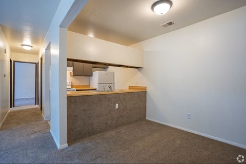 A kitchen area with a counter and a refrigerator.