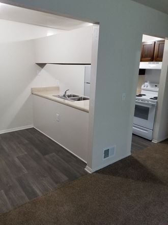 a view of a kitchen with a sink and a stove