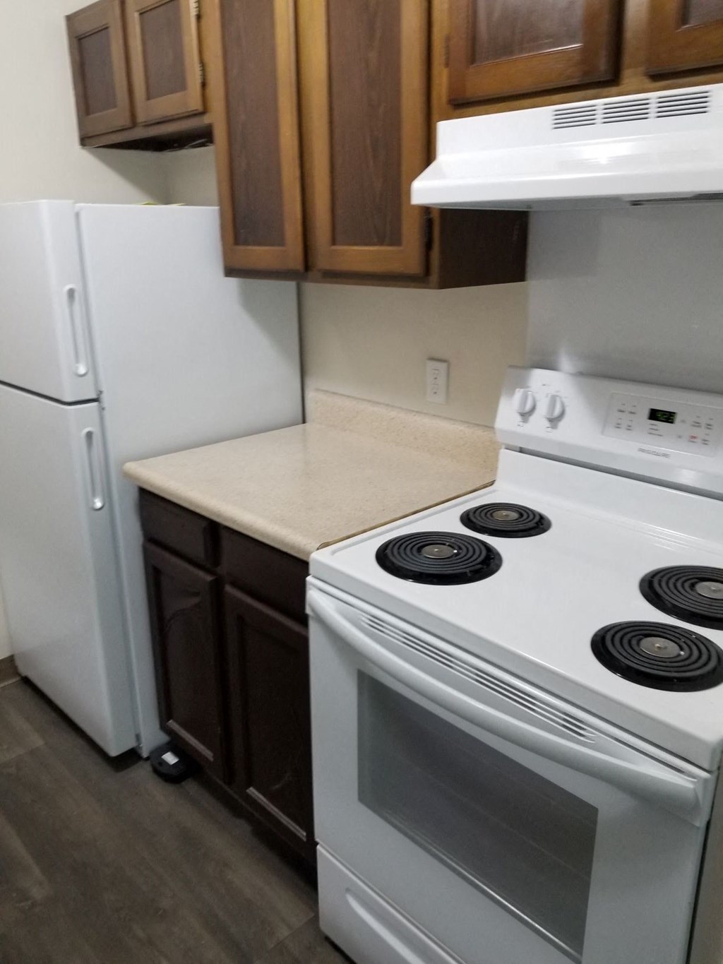 a kitchen with a stove and a refrigerator