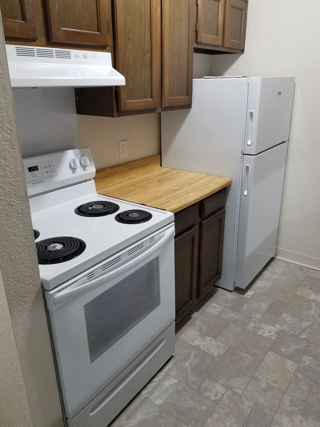 a kitchen with a stove and a refrigerator