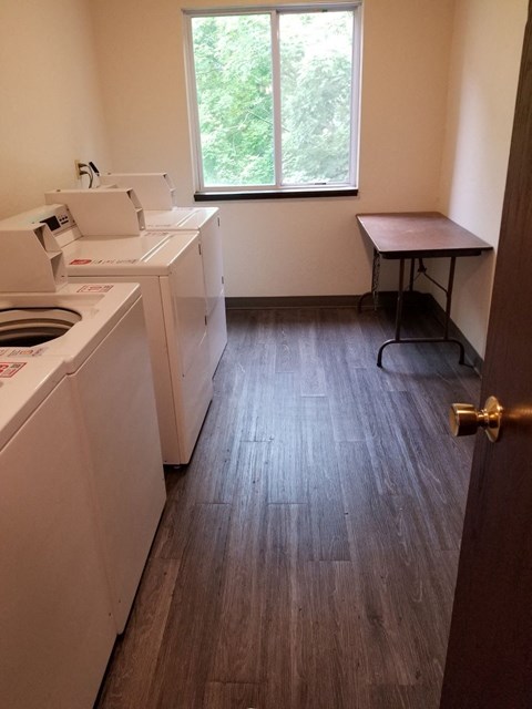 A small laundry room with a washer and dryer.