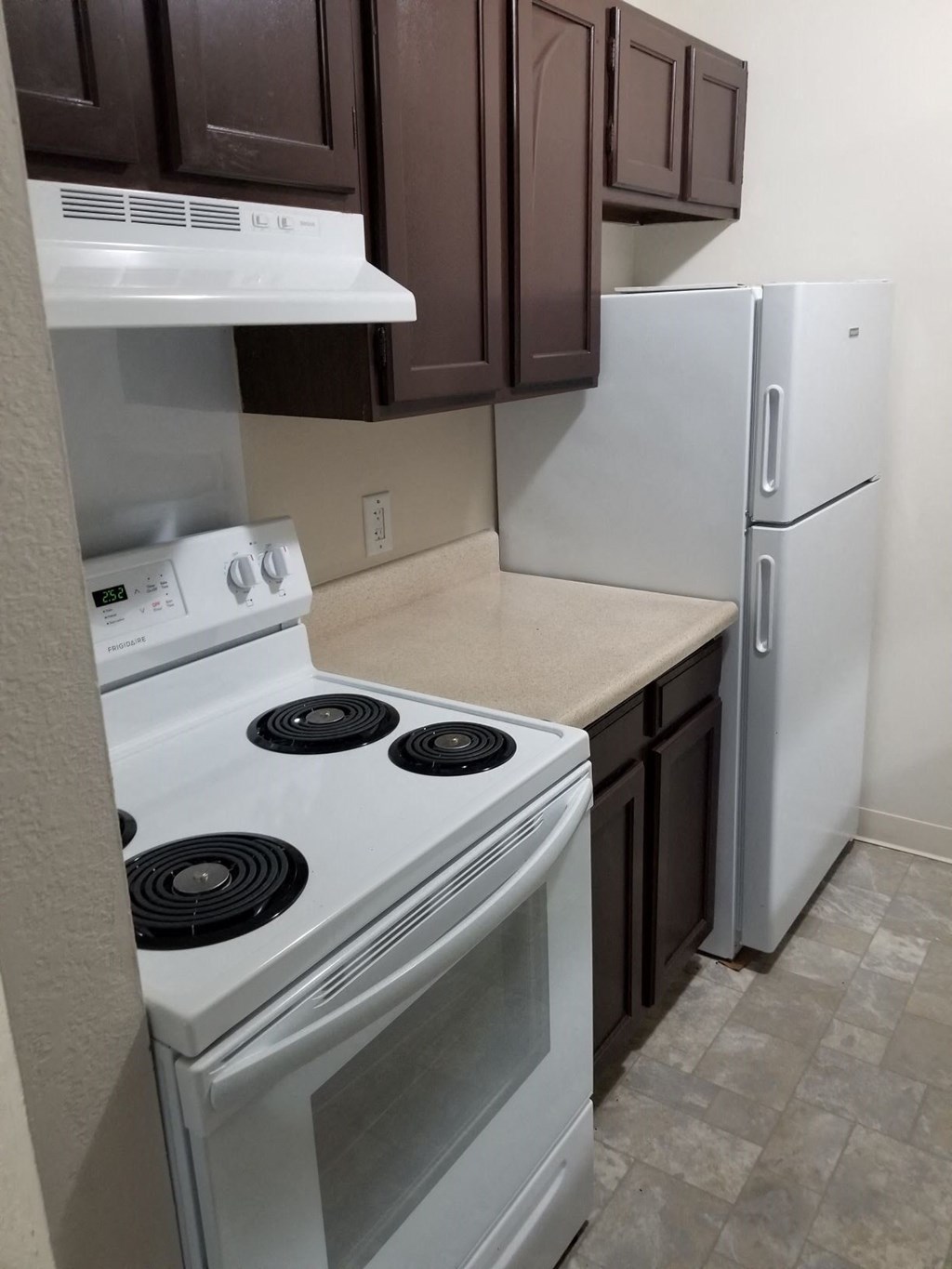 a kitchen with a stove and a refrigerator
