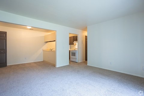A kitchen area with a refrigerator, microwave, and oven.