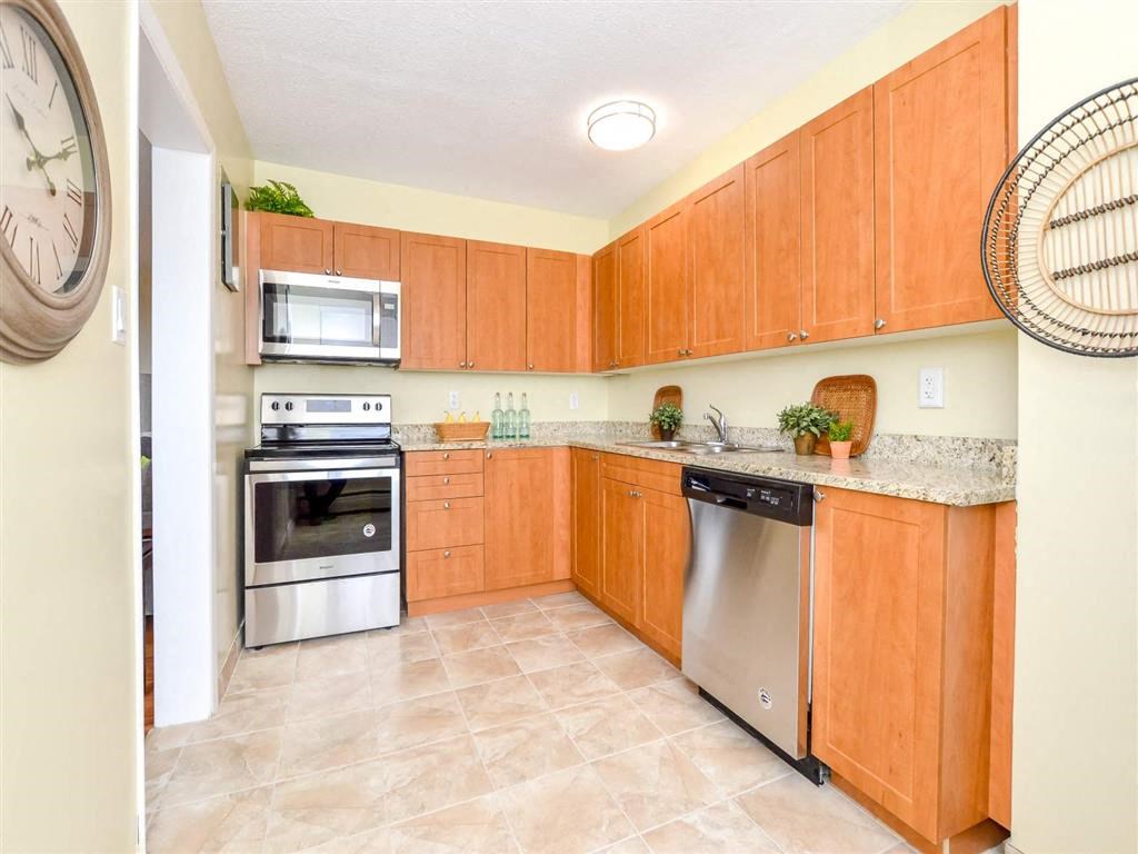 a kitchen with stainless steel appliances and wooden cabinets