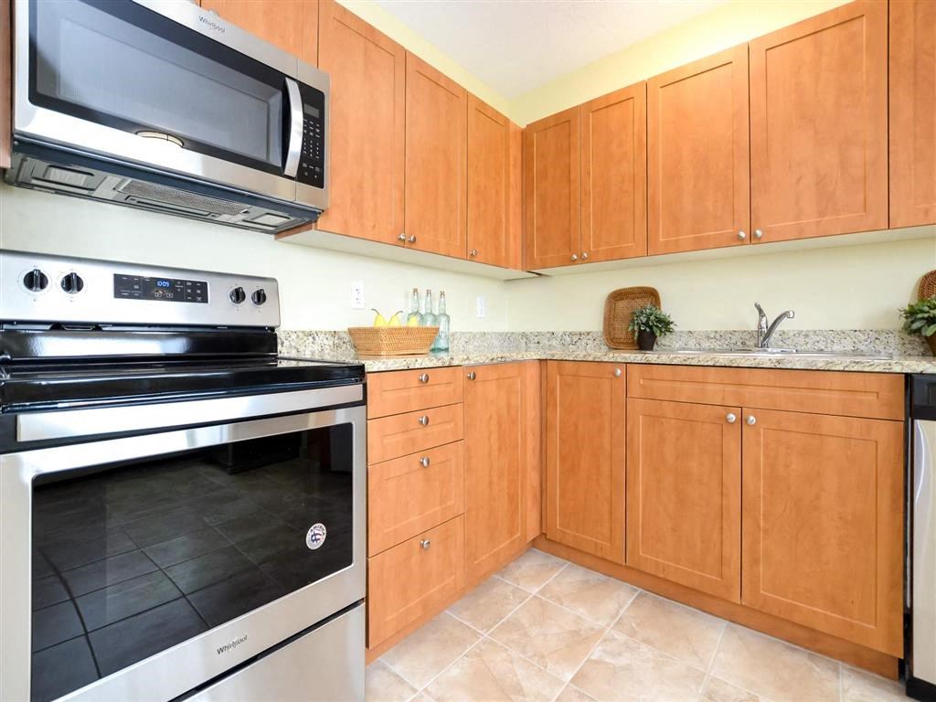 a kitchen with stainless steel appliances and wooden cabinets
