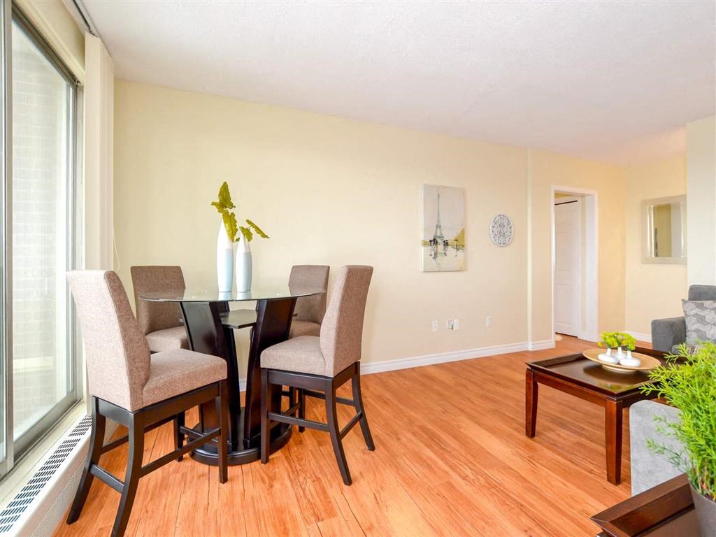 a dining room with a table and chairs in front of a window