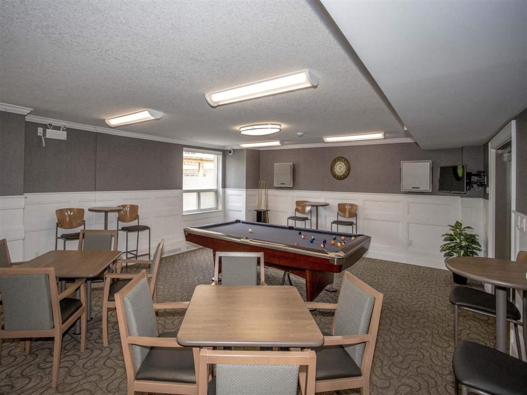 a game room with a pool table and tables