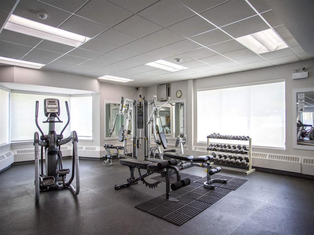a gym with weights and other equipment in a large room