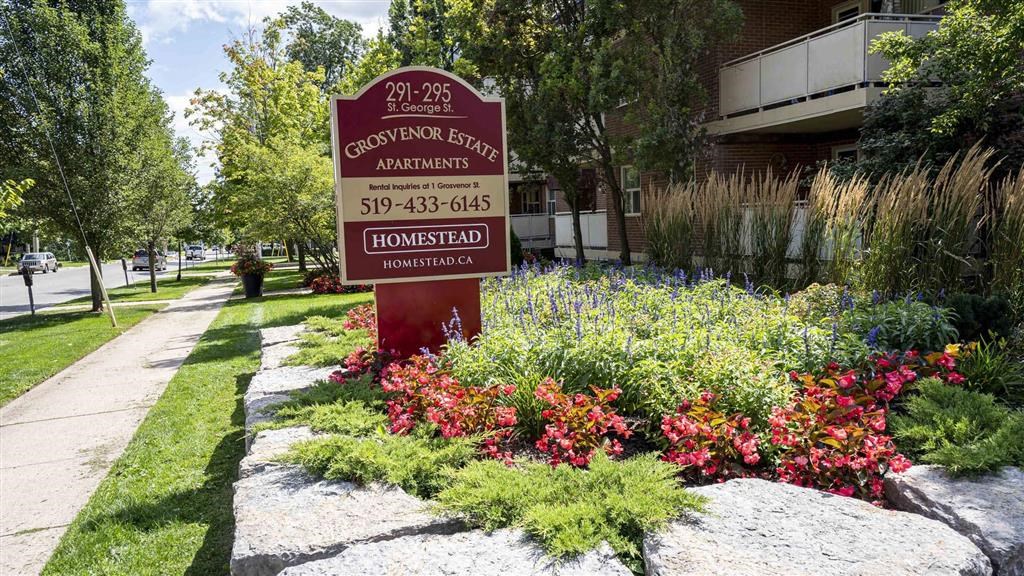 a sign in the front yard of a building