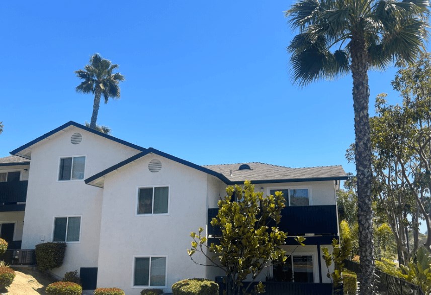 a white house with palm trees in front of it