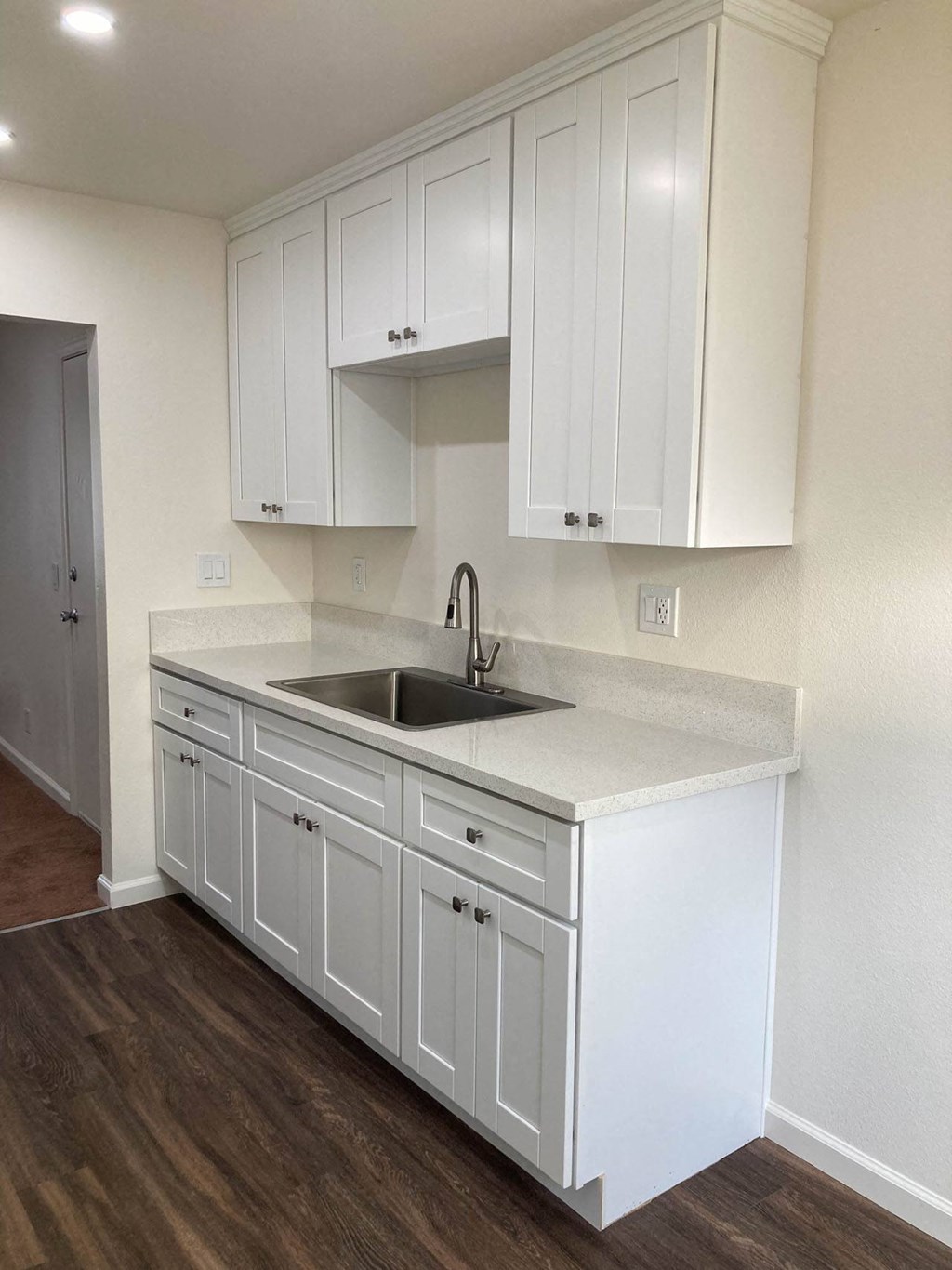 an empty kitchen with white cabinets and a sink at Casa Sol Apartments, Imperial Beach, 91932 
