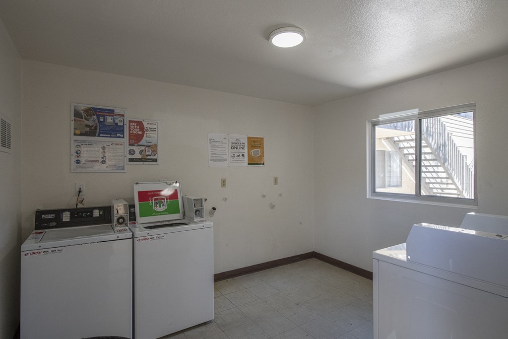 an empty laundry room with two washes and a window at Casa Sol Apartments, Imperial Beach, CA 91932