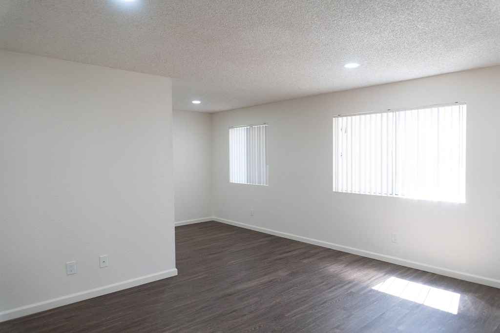 an empty living room with white walls and a window at Casa Sol Apartments, Imperial Beach