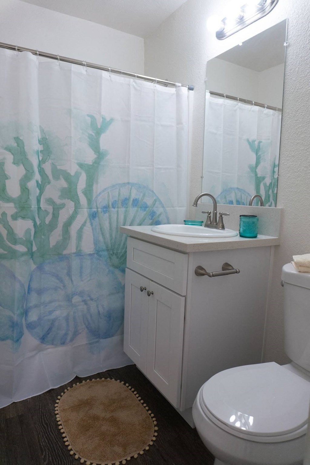 a bathroom with a shower curtain and a toilet and a sink at Casa Urbana Apartments, California, 91910