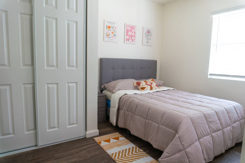 a small bedroom with a bed and a closet at Casa Urbana Apartments, California