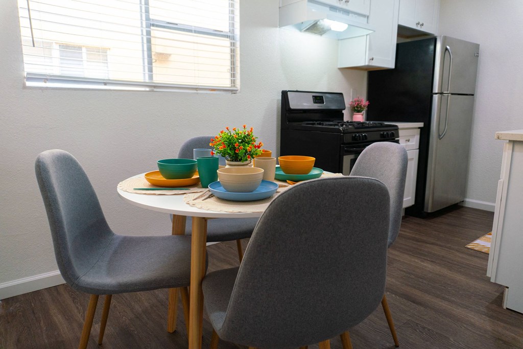 a kitchen and dining room with a table and chairs at Casa Urbana Apartments, Chula Vista