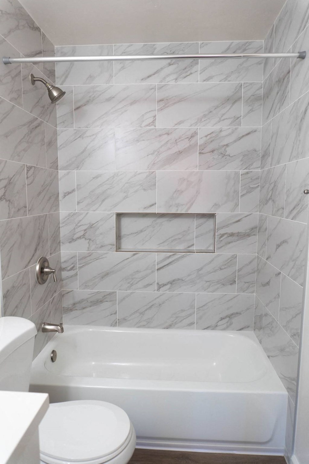 a white bathroom with a tub and a toilet at Casa Victoria Apartments, Chula Vista, 91910