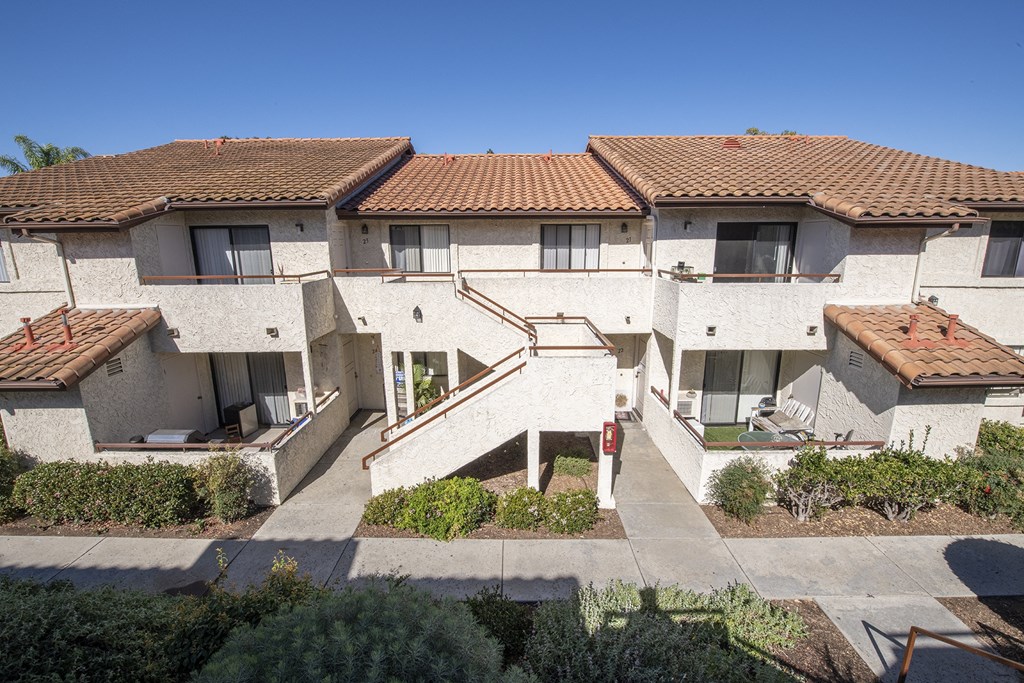 an aerial view of a row of white buildings with red roofs at Sycamore Hills Village Apartments, Vista
