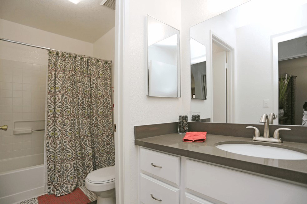 a bathroom with a sink and a shower and a toilet at Sycamore Hills Village Apartments, Vista