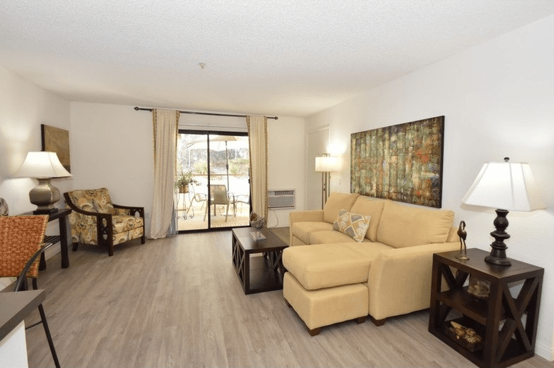 a living room with a couch and a table at Sycamore Hills Village Apartments, California, 92081