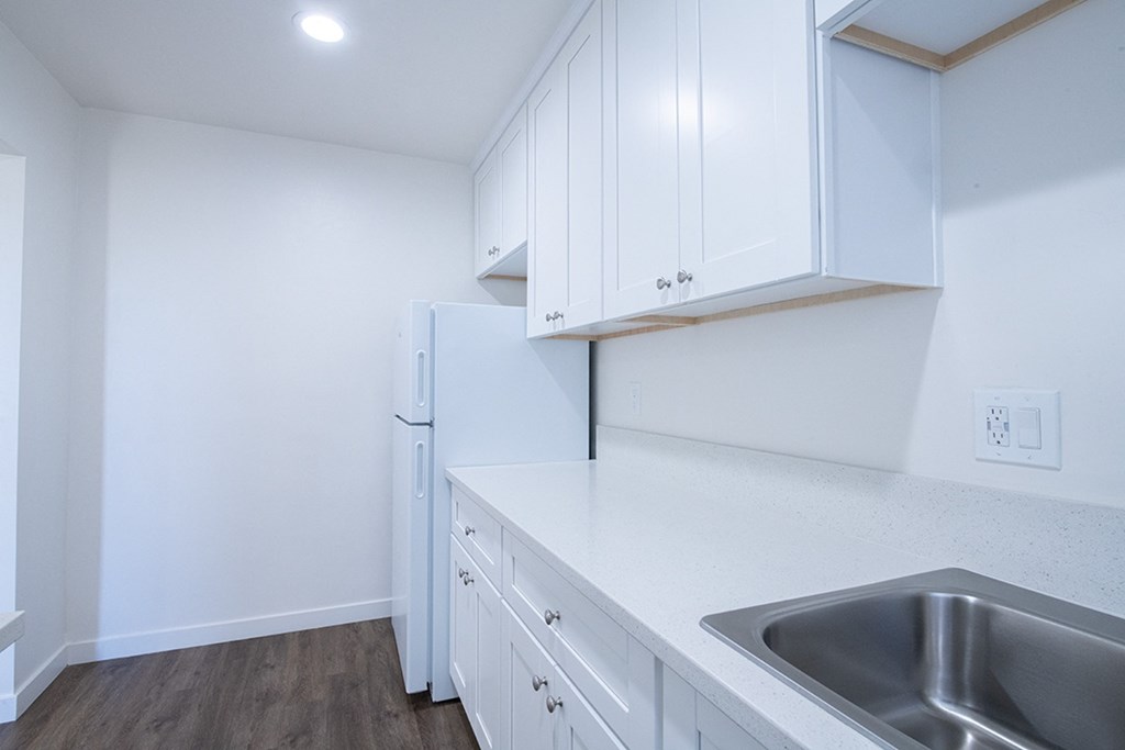 apartment kitchen with sink and refrigerator at Villa Primavera Apartments, National City California