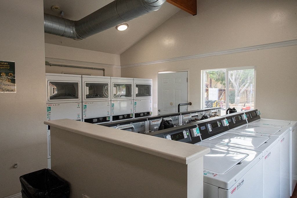 the laundry room has new washes and dryers and new windows at Villa Primavera Apartments, National City California