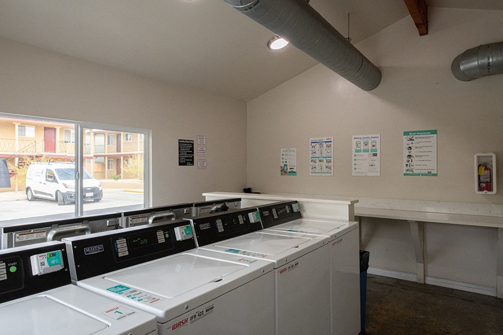 the laundry room is equipped with washers and dryers at Villa Primavera Apartments, National City, CA 91950