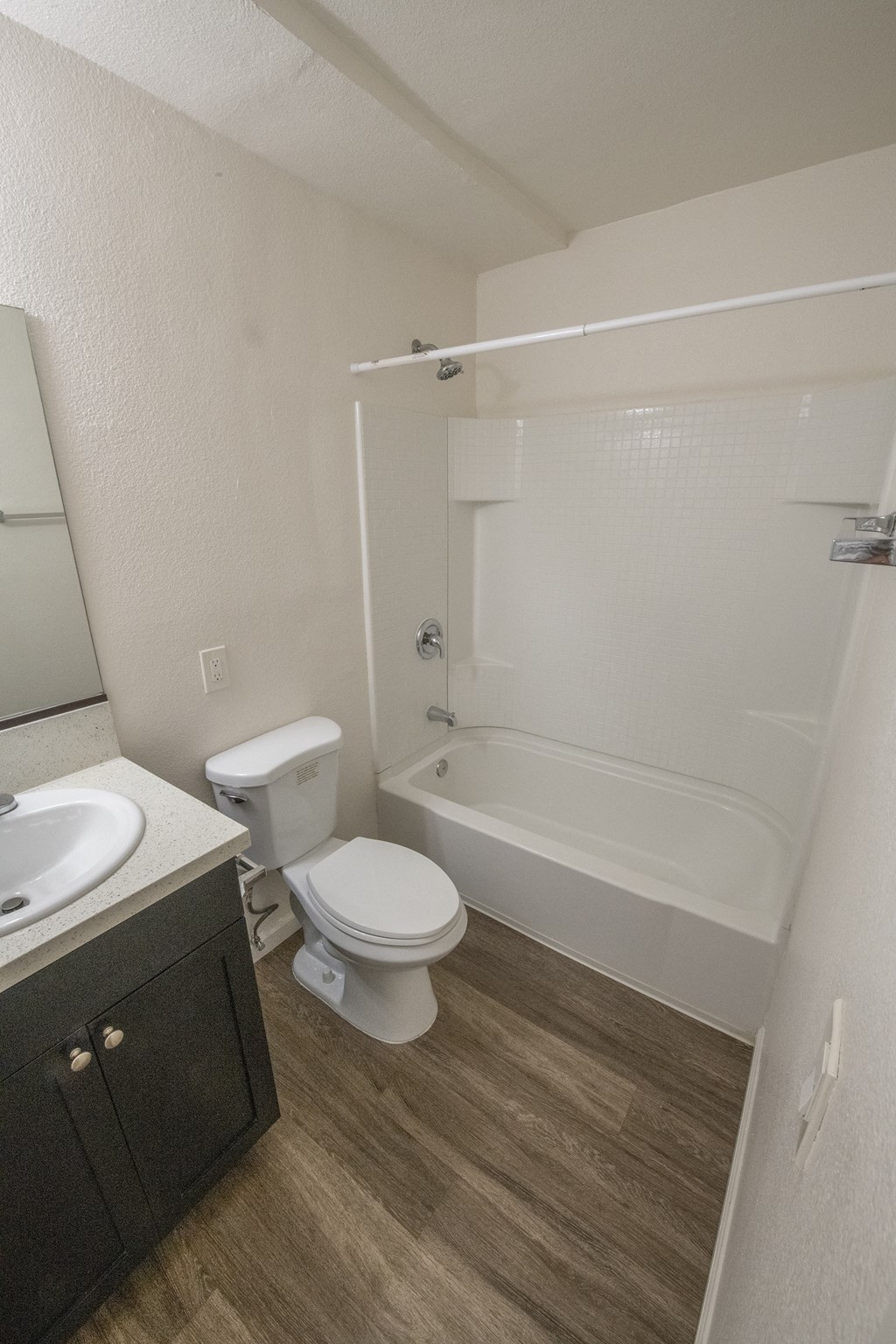 an empty bathroom with a toilet and a tub and sink  at Villa Quixote Apartments, California