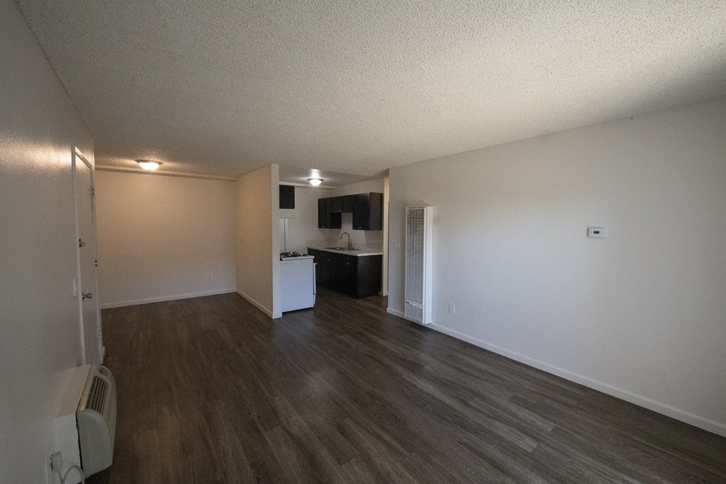 an empty living room and kitchen of an apartment at Villa Quixote Apartments, Escondido, 92025