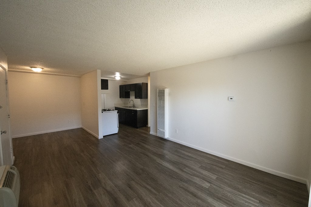 an empty living room and kitchen of an apartment at Villa Quixote Apartments, Escondido, California
