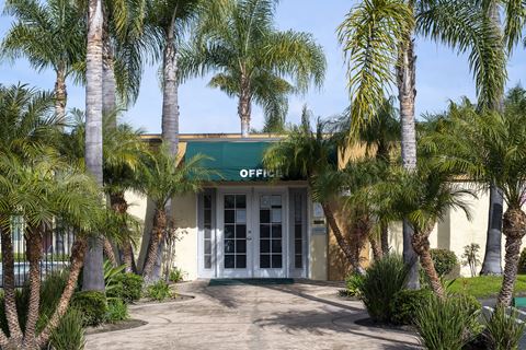 the front of the office building is surrounded by palm trees