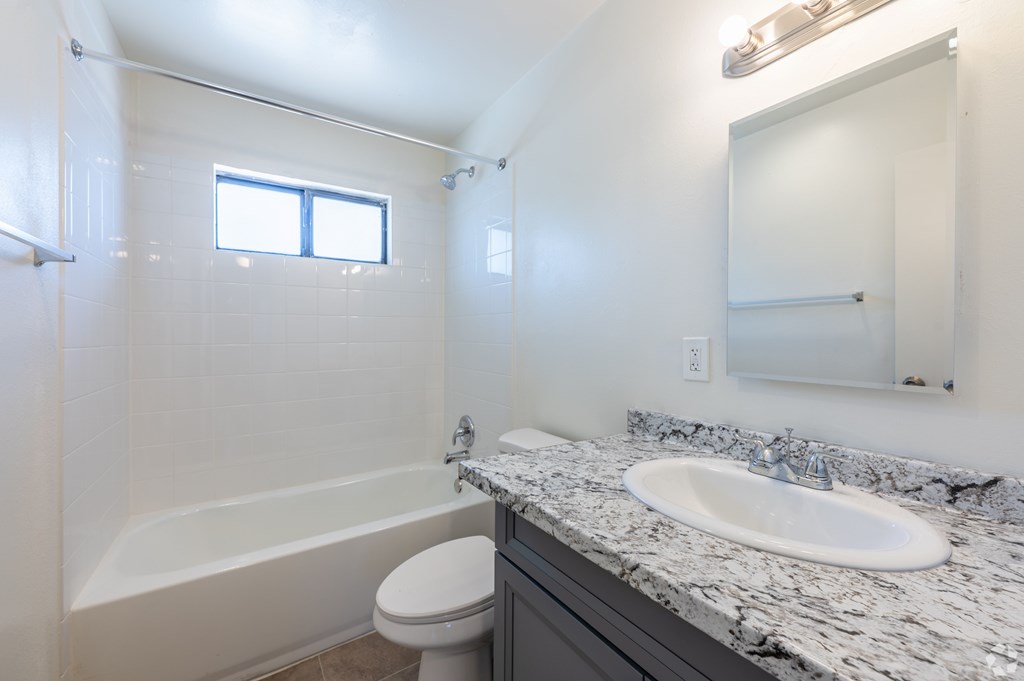 Bathroom with a toilet, sink and tub.