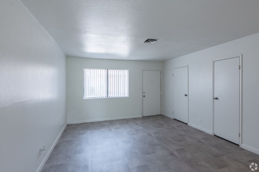 Room with a window and three doors.