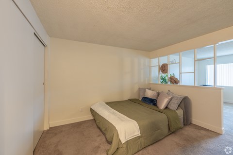 A bedroom with a bed and a window.