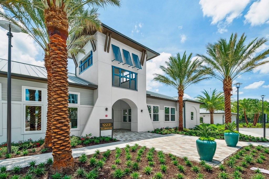 a white house with palm trees in front of it