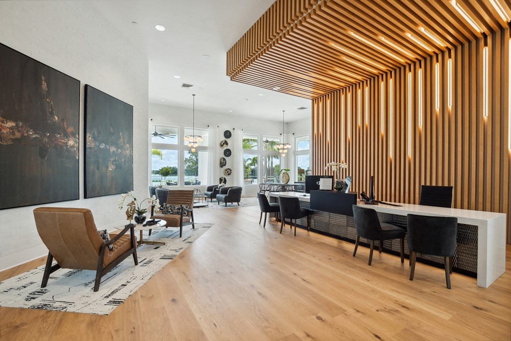 a dining room with a long table and chairs and a large window