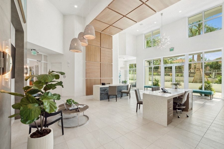 a living room and dining room with a table and chairs