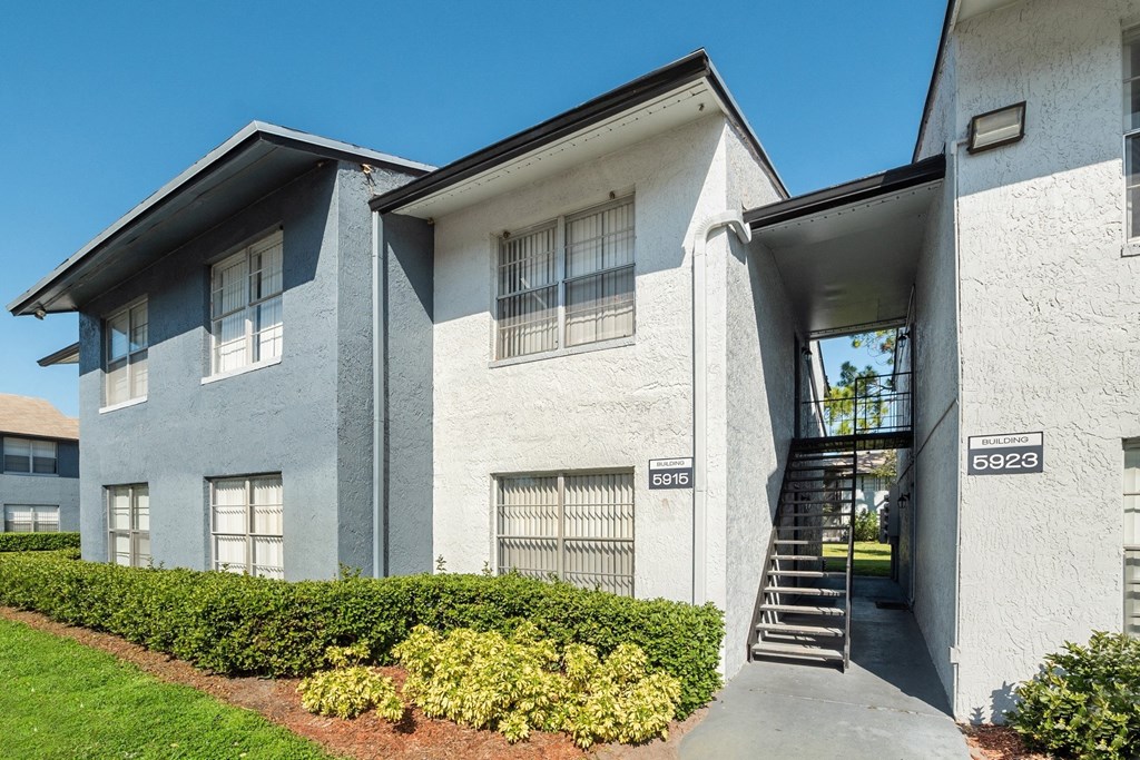 an exterior view of a building with stairs and a sidewalk