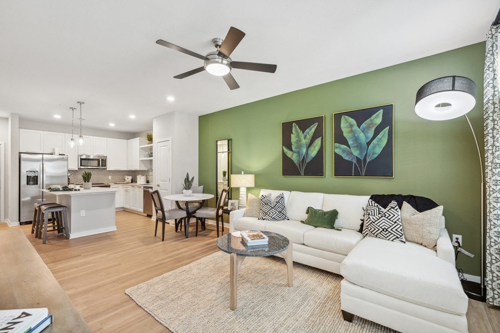 a living room with green walls and a white couch
