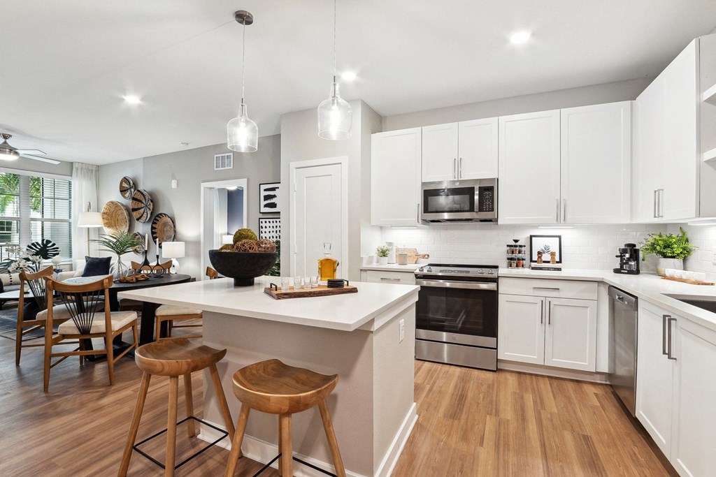 an open kitchen and dining area with a large island and stools