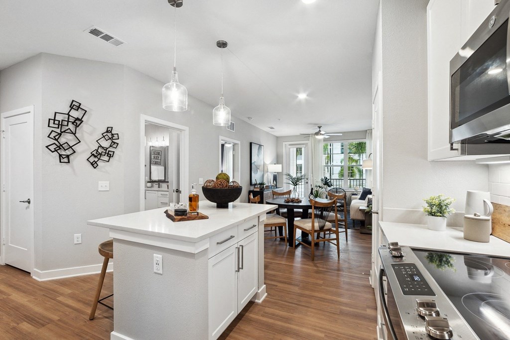 an open kitchen and living room with a dining room in the background