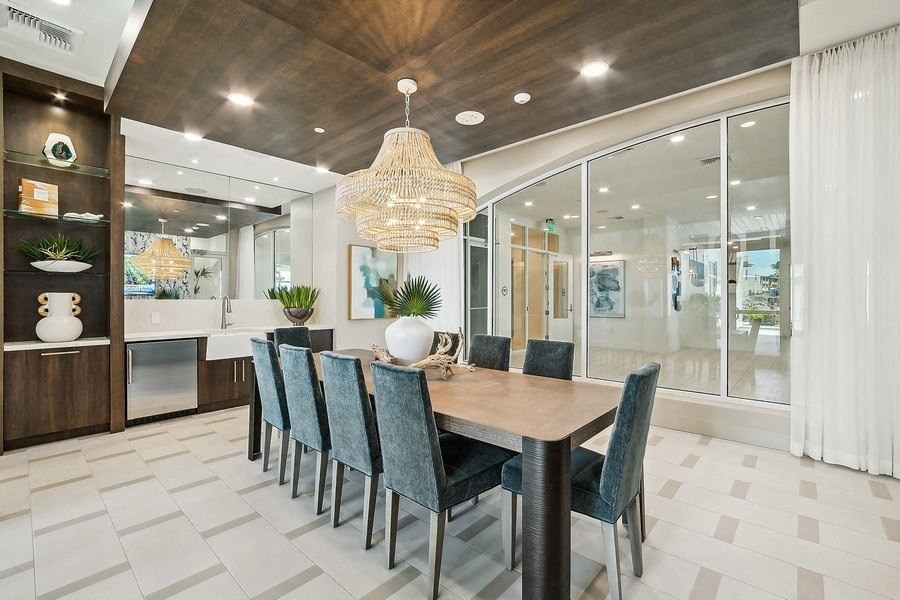 a dining room with a long table and chairs