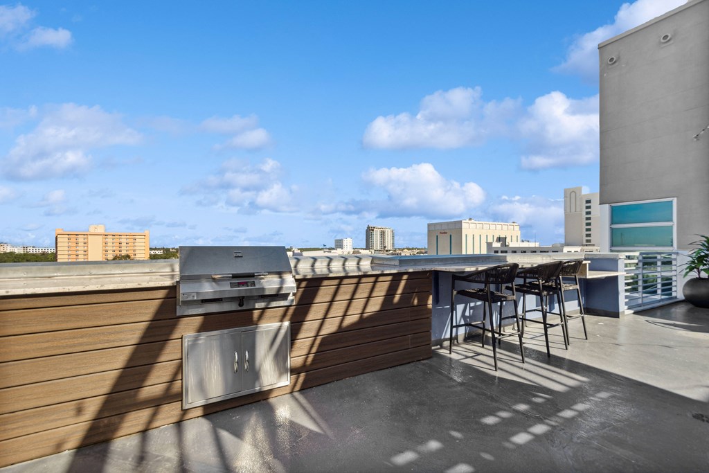 a rooftop bar with a city skyline in the background